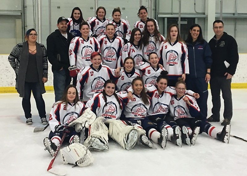 The Lac La Biche Explorer Dental Hygiene/Lakeland Denture Midget &#8216;B&#8217; Clippers female hockey team gathers together for a team picture after winning the Zone 2