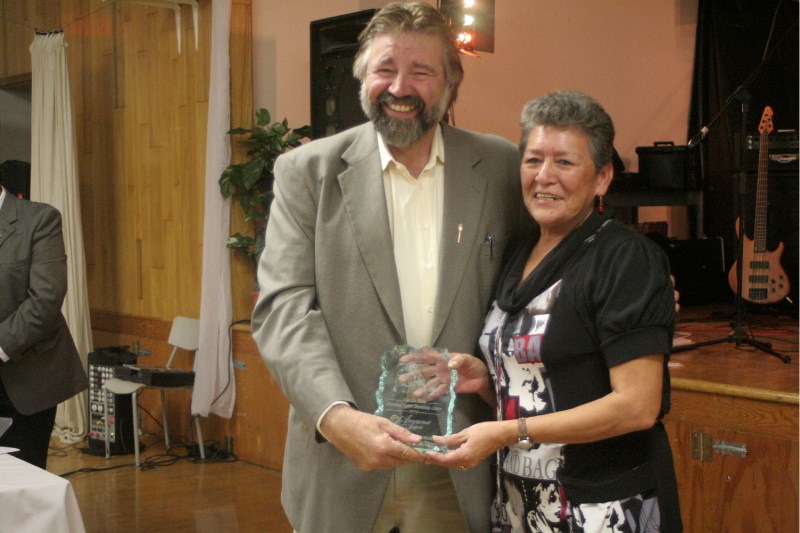 MLA Ray Danyluk presents Lifetime Achievement Award winner Violet Cardinal with her trophy