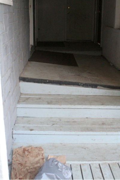 Paper bags left over from squatters lay at the bottom of the slanted stairs near the fire escape.