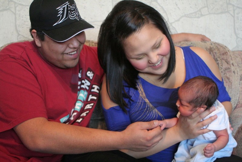 Parents Travis White and Tanya Desjarlais hold the first baby of 2011, Gerald Trevor White.