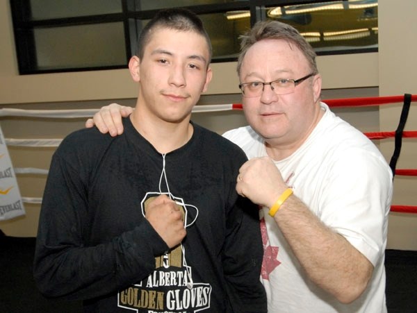Golden Gloves gold medalist John Mountain (left) and boxing coach Ken Scullion pose for a photo in the new home of the Lac La Biche Boxing Club at the Bold Center.