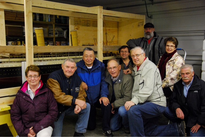 Members of the Lakeland Interpretive Society pose next to the 98-year old Empress of France ship model that they donated $100,000 to have restored.