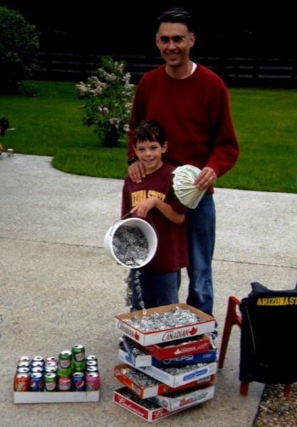 Kirk Plamondon and his son with some of the tabs that his students in Chandler, Arizona, have collected over the last ten years.