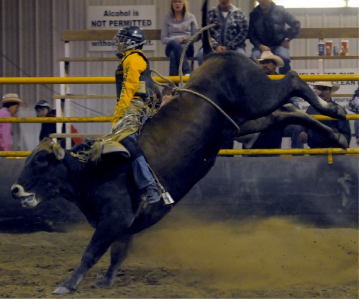 Alex Delorme, 14, rides a bull at the North American Indian Rodeo Association regional finals in High Prairie in September.