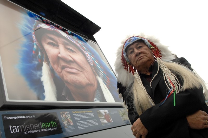 Former Beaver Lake Cree Nation chief Al Lameman stands next to his portrait as part of an exhibition in London in September 2010.