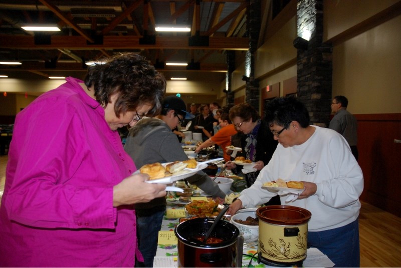 People help themselves at an international feast served at the Bold Center on Saturday.