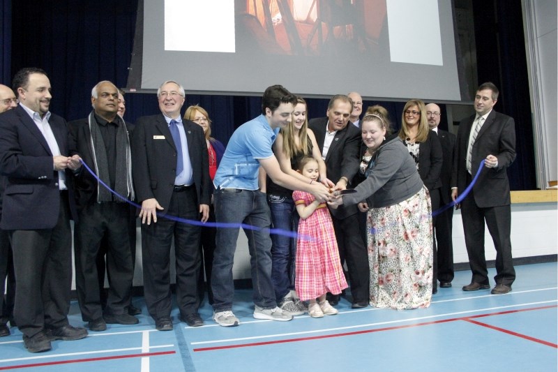 école Plamondon School students and NLSD board members cut the ribbon for the school&#8217;s newly expanded wing.