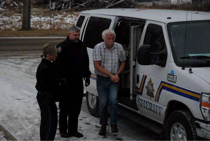 Daniel Quiring Stoesz, 62, arrives at court with provincial sheriffs Dec. 5.