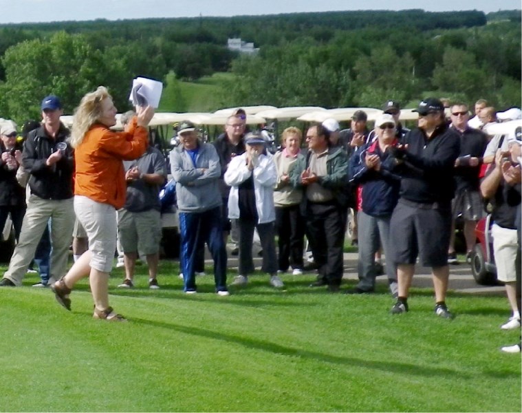 Volunteer Jane Palmer rallies the crowd at last summer&#8217;s Cormorant Classic golf tourney, where Lac La Biche County officials say there were no councillors
