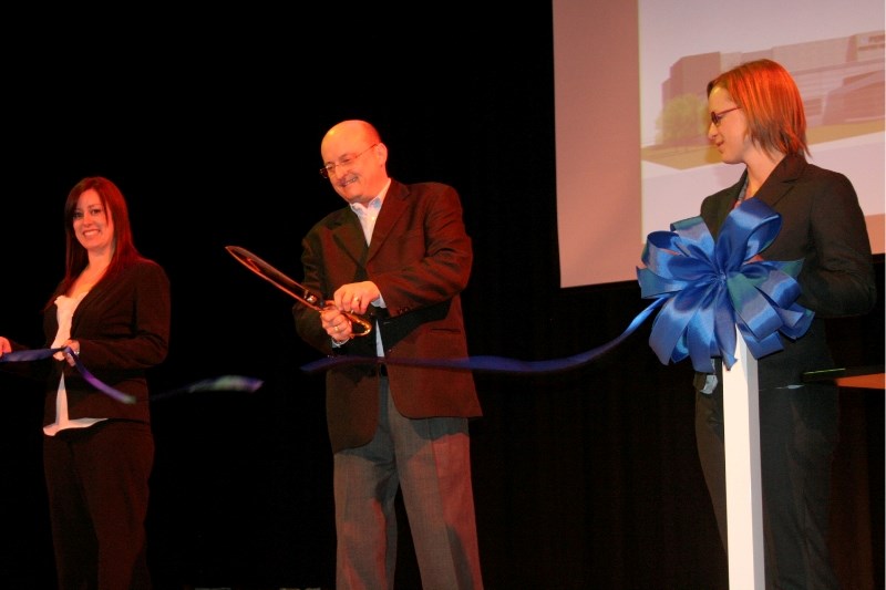 Portage College President Dr Trent Keough cuts a ribbon at the McGrane Theatre while marketing manager Felicity Bergman (left) and Water Resources Manager Lindsay Johnson