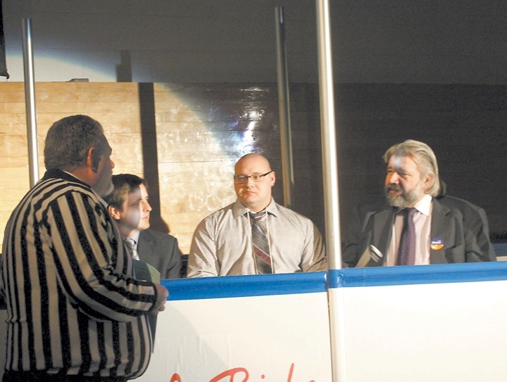 Rival politicians (from left) Shayne Saskiw, John Nowak, and Ray Danyluk share the penalty box after they were penalized for &#8220;excessive schmoozing&#8221; at the Sports