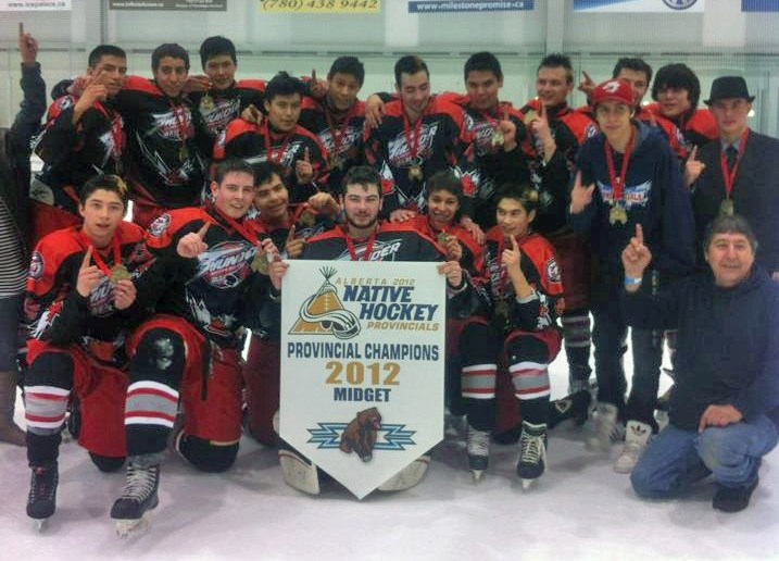 Members of the St. Albert Thunder pose with their Championship banner at the annual Native Hockey tournament in Edmonton.
