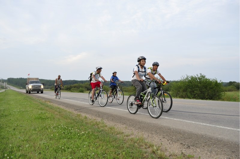 From left: Blair, Keith, Madison, Craig, and Shannon in front of their support vehicle, driven by Keith&#8217;s wife Candace.