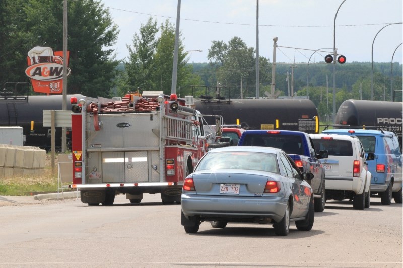 A firetruck stuck behind a train in the Hamlet of Lac La Biche. The CN switching yard has been an ongoing frustration for the community, blocking traffic on a daily basis.
