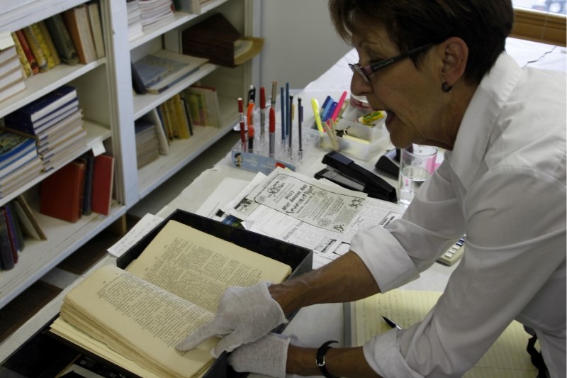 Emilie Chevigny from the Lac La Biche Mission shows off some of the literature on hand at the historic settlement. Chevigny and her colleagues plan to digitalize and share