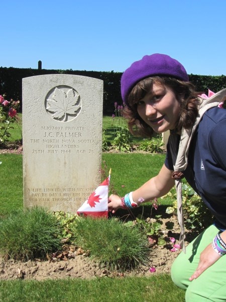 Venturer Scout Jessi Plamondon plants a Canadian flag on the grave of her long-lost great-great-uncle who died fighting with the North Nova Scotia Highlanders in WWII.