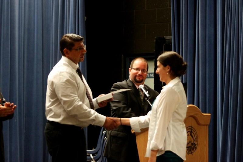 Principal Terry Moghrabi hands Meagan Anderson another cheque and award at the 2012 J.A.W.S grad awards. Anderson took home more than $2,500 in scholarship money to aide in