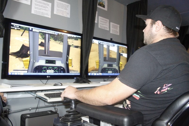 Drew Edwardson, a student in the Heavy Equipment Operator program works in the Heavy Equipment mobile training unit at Portage College. Edwardson will log 40 hours in the