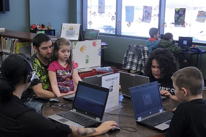 Organizer Erin Hunter, Martin Dufault, Maggie Dufault, Omry Boucher and Landon Dufault play Minecraft at the Stuart McPherson Public Library Saturday.