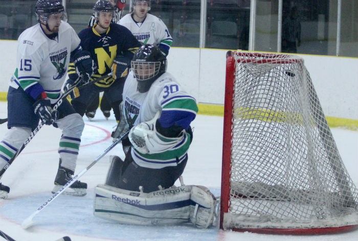 Voyageurs goalie Kirby Halcrow looks over his shoulder after NAIT&#8217;s Michael Piluso scored the first of two goals