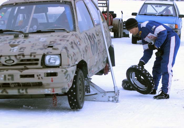 Ice racer Hiroki Currie changes his tires before practice on day one of the Winter Festival of Speed.