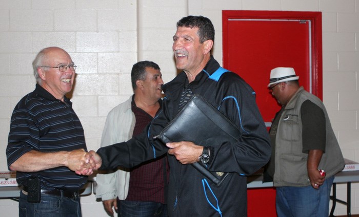 Lac La Biche County mayor-elect Omer Moghrabi shakes hands on the way into his election party at the Kinsmen Hall in Lac La Biche.