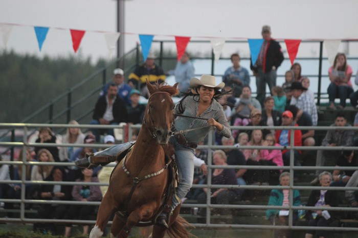 Seanna Merchant, a ladies barrel racer from Hylo, leans into the corners at the Lac La Biche Open Rodeo Aug. 1.