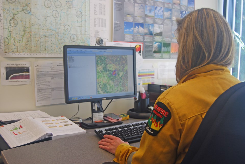 Wildfire management specialist Maria Sharpe demonstrates using the Prometheus program to forecast wildfire growth.