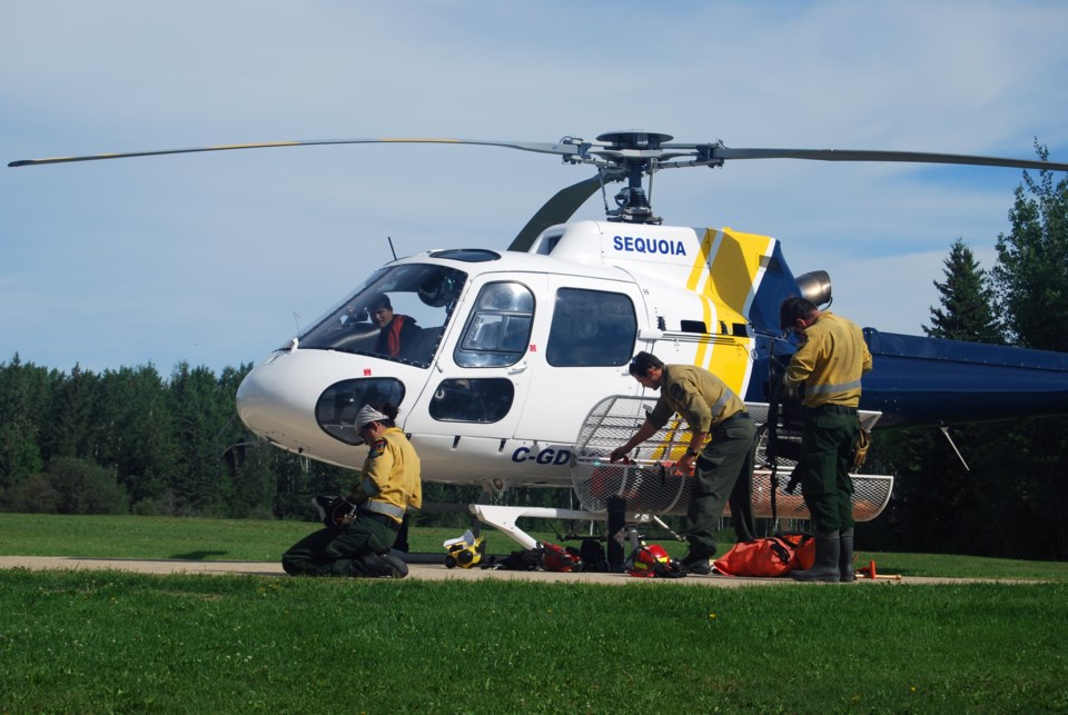 A &#8220;helitack&#8221; fire crew readies for departure from the base east of Lac La Biche.
