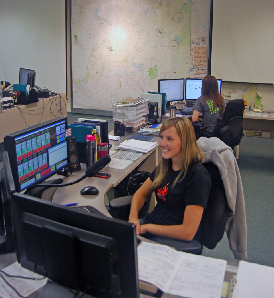 Dispatchers man their stations, receiving reports and relaying information.