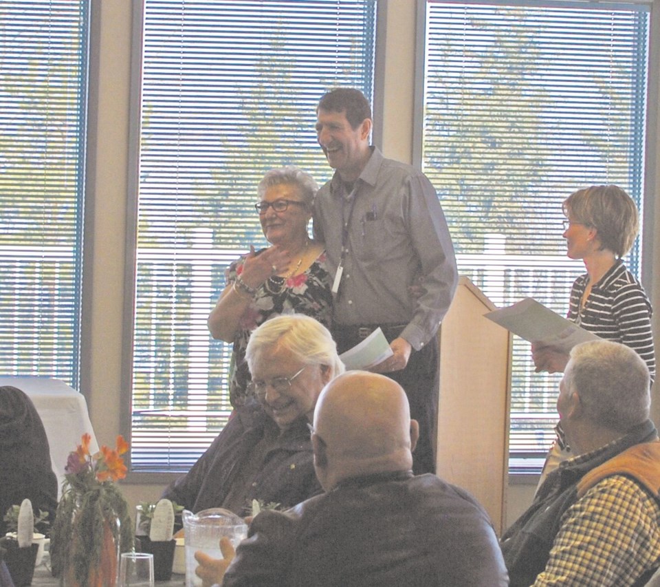 Stella Scott, a volunteer with Lac La Biche Disability Services, receives congratulations from Mayor Omer Moghrabi.