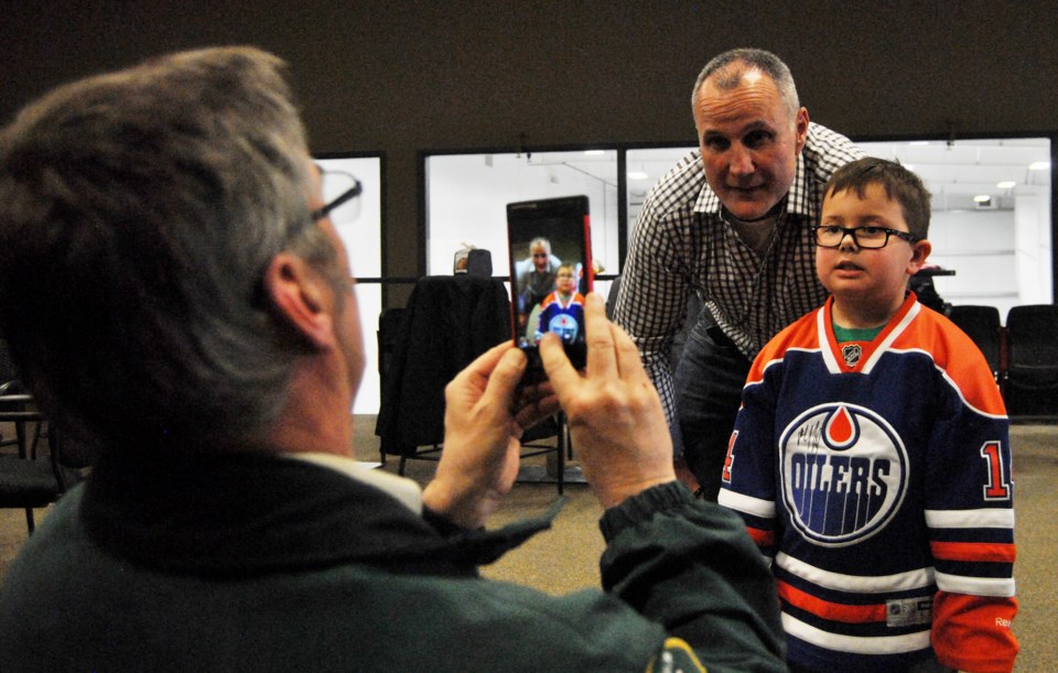 Paul Coffey poses with young fan John Butner during a meet and greet at the Bold Center last Friday.