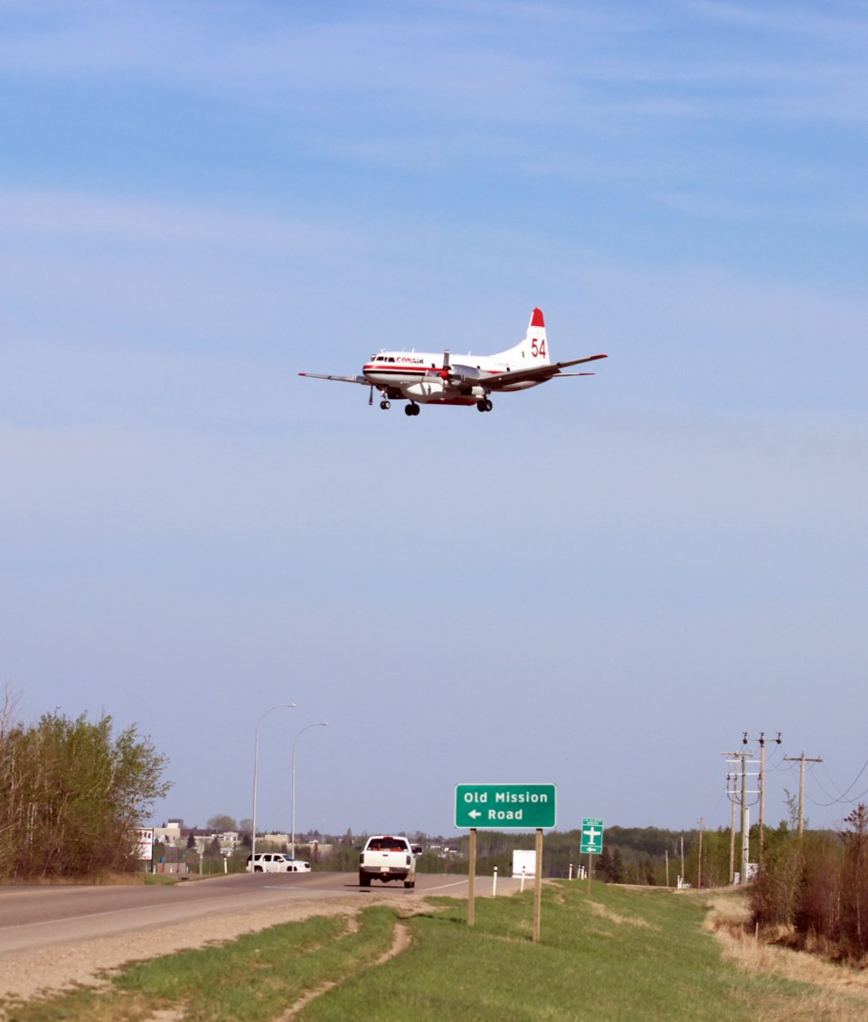 A firefighting aircraft prepares to land at the airport west of Lac La Biche.