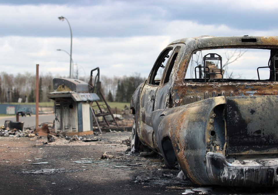 A barbecue and the burned shell of a truck remain in Beacon Hill, near the south end of Fort McMurray.