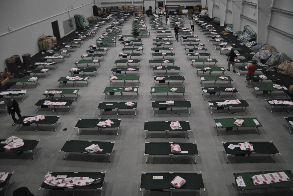 Row on row of cots stand empty in the Bold Center&#8217;s curling rink.
