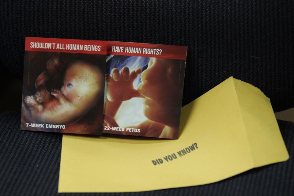 This pamphlet unfolds to depict a graphic image of a fetus with its