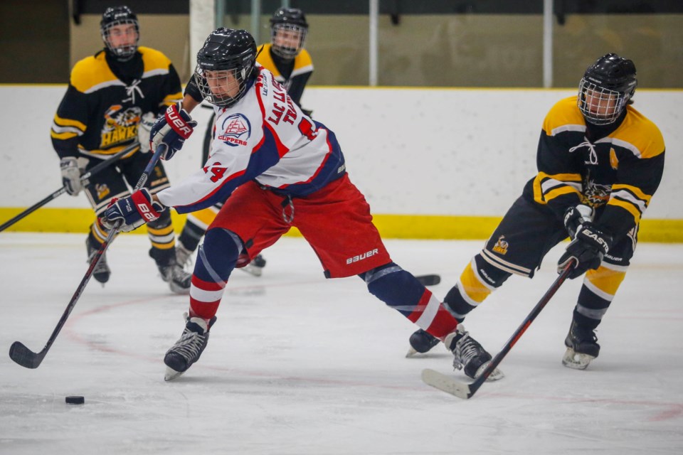 Clippers assistant captain Dawson Boucher carries the puck into Athabasca&#8217;s offensive zone.