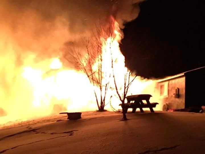 Yvonne Poholski took this photograph after she and her family backed up from their burning house. She said she wanted to prove to herself later that the fire was a bad dream.