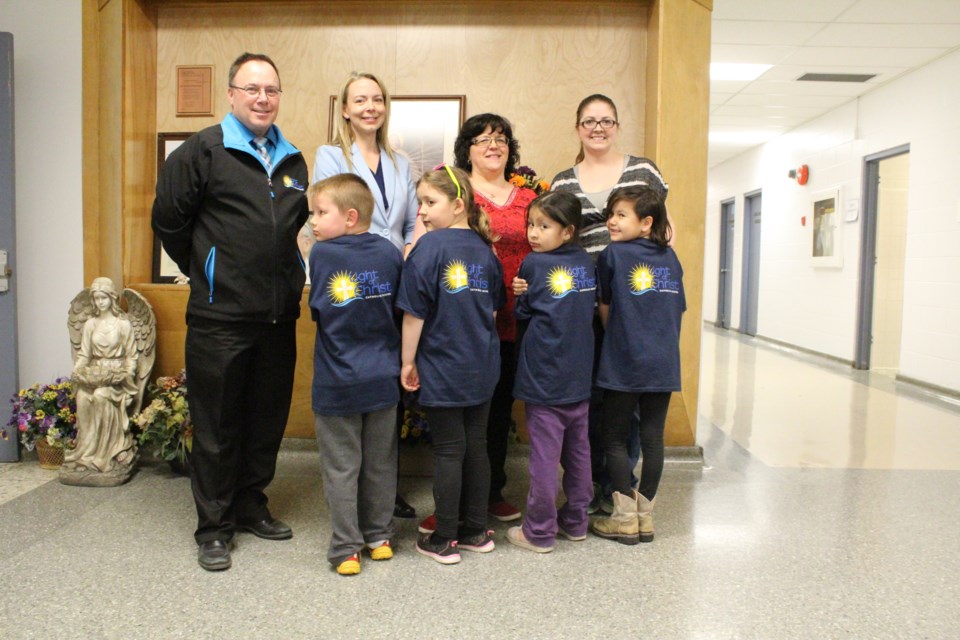 Front row, left to right, Maxx Cardinal, Sienna Theroux, Tiffany Cardinal and Micki Berland show their school spirit in Light of Christ Catholic School T-shirts offered at