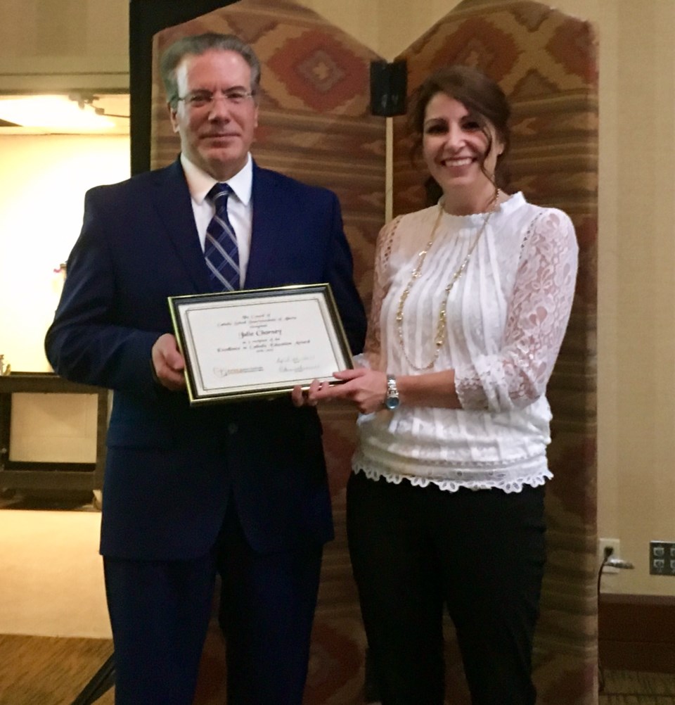 Julie Chorney, right, poses with Lakeland Catholic School Board superintendent Joe Arruda at the Blueprint conference earlier this month as she&#8217;s awarded the Excellence 