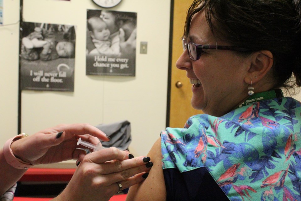 Christine Guinand, a dental assistant with Alberta Health Services, was among many Albertans who got the flu shot this week. The vaccine first started being administered on