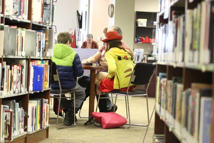  A group of superheroes were located playing board games at the library