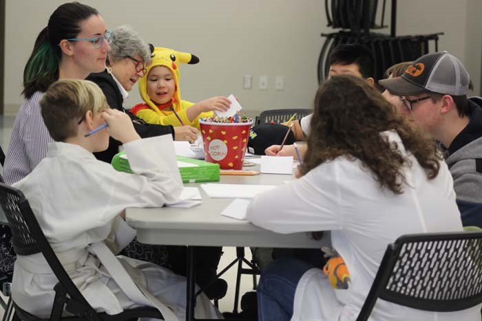  Edmonton based illustrator Mel Hohn in an illustration workshop with the kids teaching them how to create their own comic story