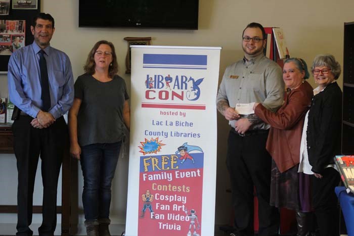 Mayor Omar Moghrabi was also present when Boston Pizza manager Devon Wheaton presented a $1200 cheque to Library Director Maureen Penn and Library Board Chairperson Loraine Anderton