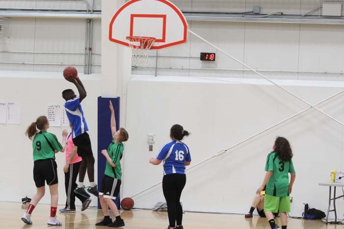  Zone 1's power forward jumps up to shoot while Saturday's qualifier mixed basketball game against zone7