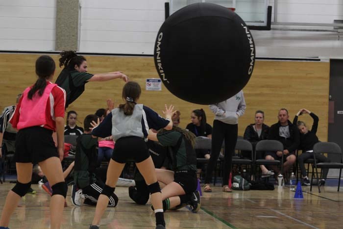  Zone 5 participant screams 'Omnikin' as she pushes the ball away during Saturday's Kinball competition at the Portage College gym