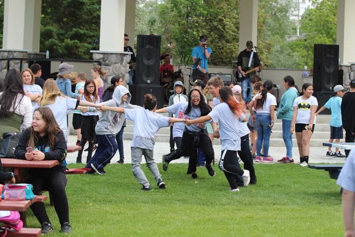  School kids enjoy and dance in circles to music by a local band called Last Minute