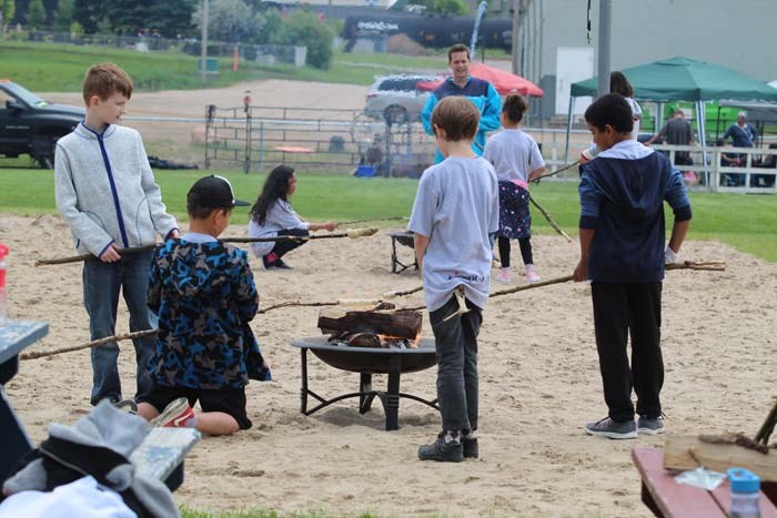  Students from the Light of Christ School couldn't wait to taste Bannock on a stick. For some it was their first time giving it a try