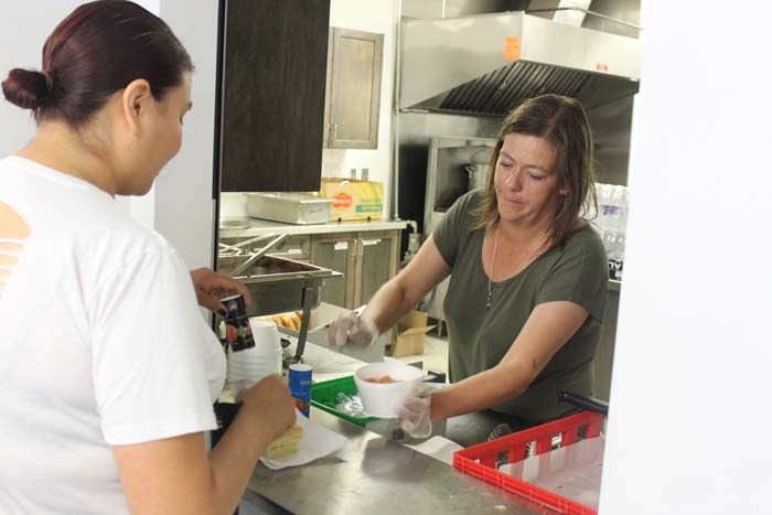  Rachelle Feledichuk volunteers in the McArthur Room kitchen serving attendees traditional hot stew for supper