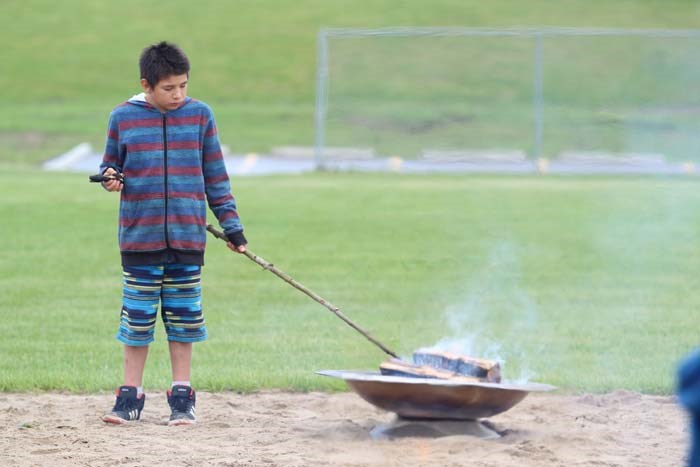  Aurora student Mason Smallface seemed to know what he was doing — except for the already burnt bannock on a stick in his hand